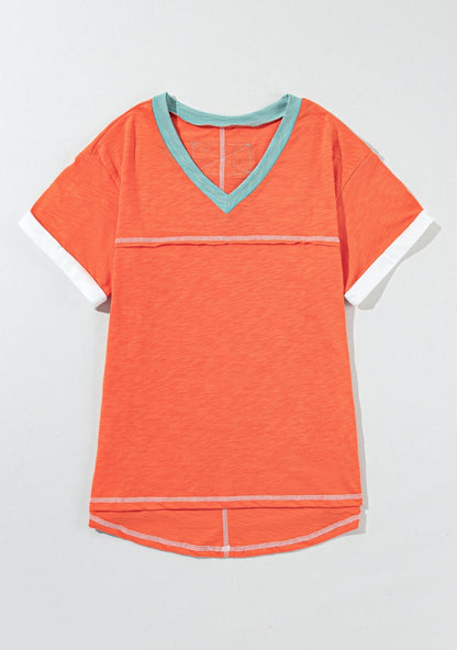 Orange tee with aqua trim around v-neck & exposed seams